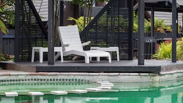 Outdoor pool, a heated pool, open 8:30 AM to 8:00 PM, pool loungers