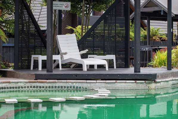 Outdoor pool, a heated pool, open 8:30 AM to 8:00 PM, pool loungers