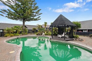 Outdoor pool, a heated pool, open 8:30 AM to 8:00 PM, pool loungers