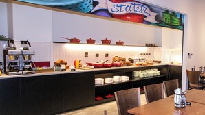 A restaurant with a counter, chairs, and a coffee machine.