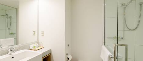 A bathroom with a sink, toilet, and shower.