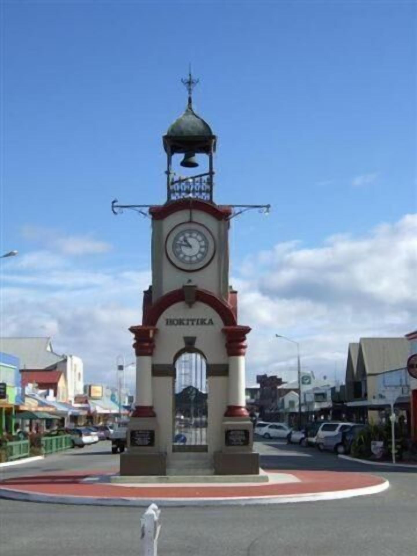 A clock tower with a dome and a weather vane at the top, labeled "BOKTIKA".