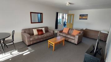 Two-Bedroom Apartment | Living area | 32-inch LCD TV with satellite channels, TV