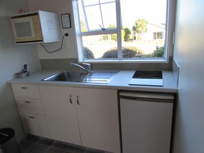 Fridge, microwave, coffee/tea maker, cookware/dishes/utensils