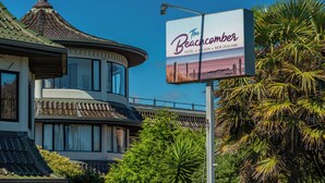 A hotel with a traditional architectural style, featuring a curved roof and multiple windows. - The Beachcomber Hotel (Nelson)