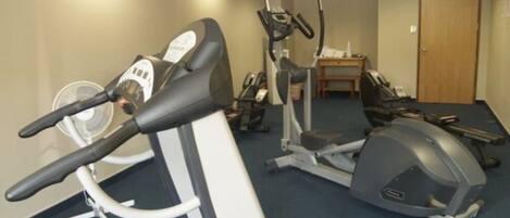 A gym with stationary bikes and treadmills.