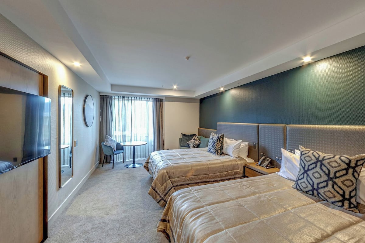 deluxe twin room, 2 queen beds | in-room safe, iron/ironing board, free cots/infant beds, free wifi