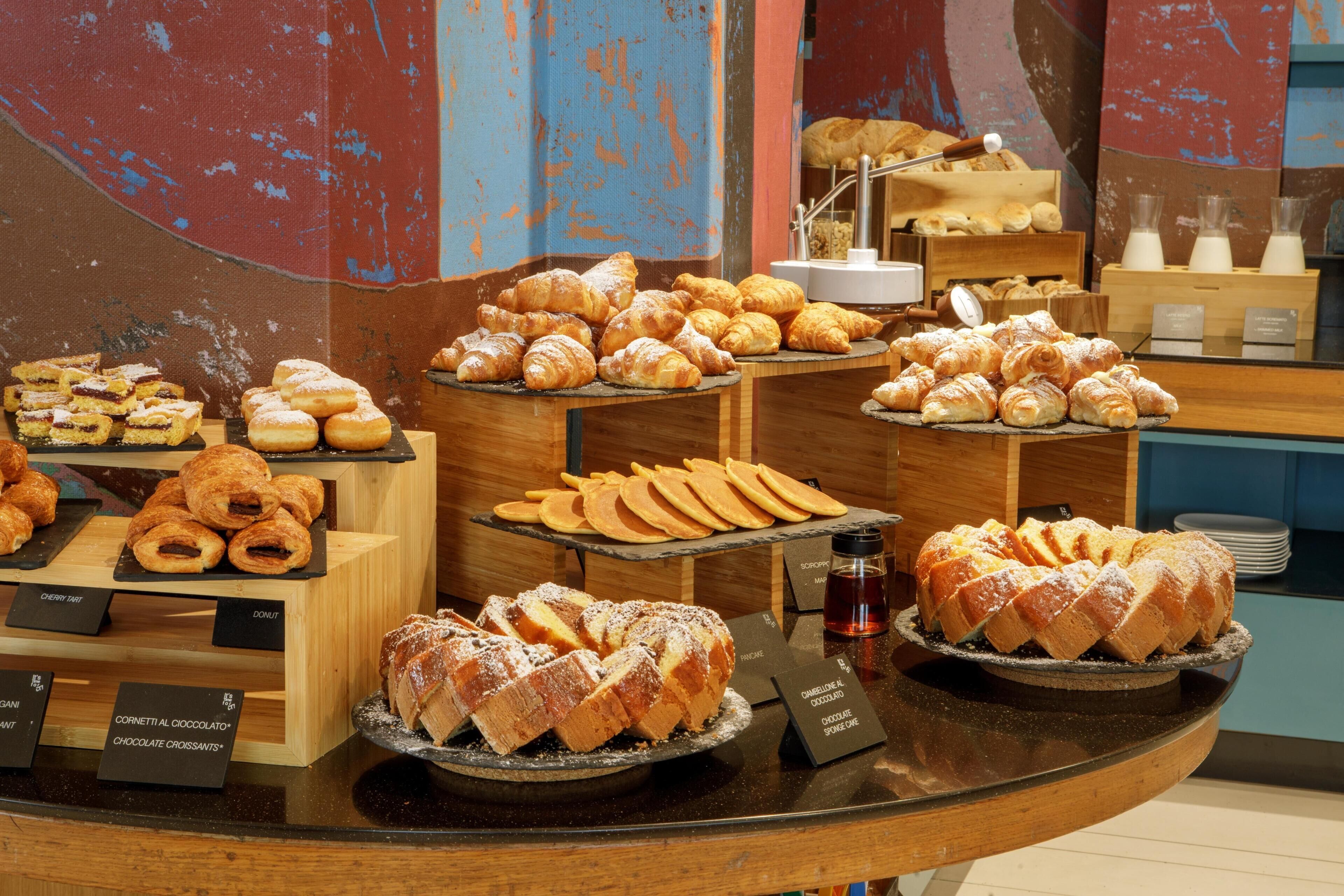 A bakery display with various pastries and desserts.