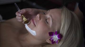 A person lying down with a flower in their hair.
