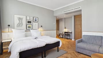Un dormitorio moderno con una cama grande, un sofá y una zona de comedor.