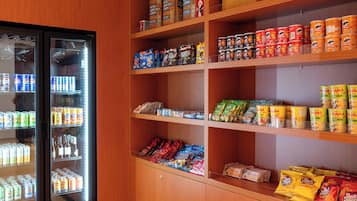 A snack and beverage vending area with various products including canned goods, snacks, and beverages.