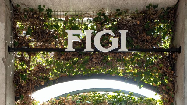 An archway with the word 'FIGI' above it, leading to a building entrance. - Hotel Theater Figi (Zeist)