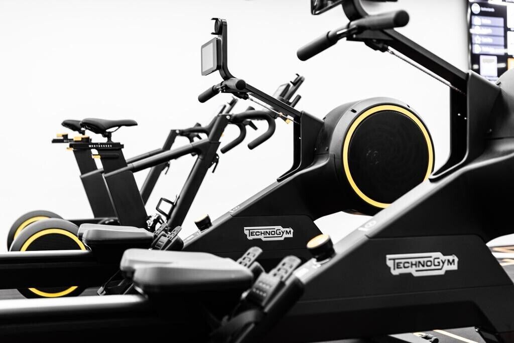 A stationary bike with a digital display and a handlebar.