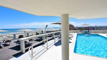 Seasonal outdoor pool, open 8:30 AM to 8:00 PM, pool umbrellas