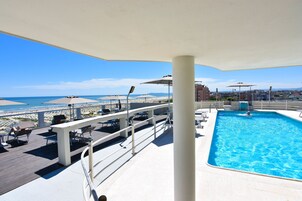 Seasonal outdoor pool, open 8:30 AM to 8:00 PM, pool umbrellas