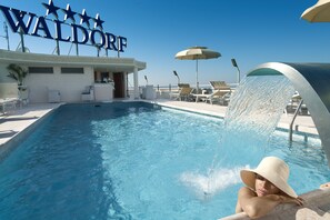 Seasonal outdoor pool, open 8:30 AM to 8:00 PM, pool umbrellas