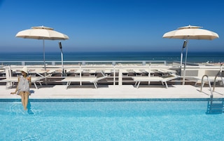 Seasonal outdoor pool, open 8:30 AM to 8:00 PM, pool umbrellas