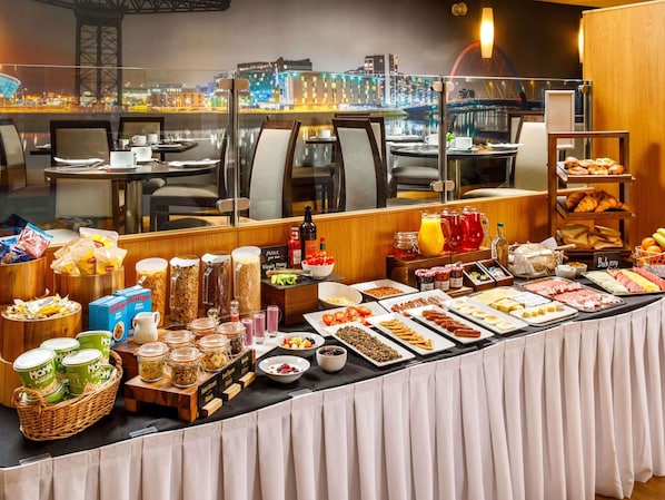 A buffet with various food items and condiments.