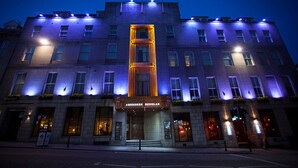 A multi-story hotel with a prominent entrance and illuminated signage. - Aberdeen Douglas Hotel (Aberdeen)