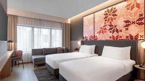 A hotel room with two beds, a desk, a sofa, and a large window with curtains. - Grand Mercure Kuala Lumpur Bukit Bintang (Kuala Lumpur)