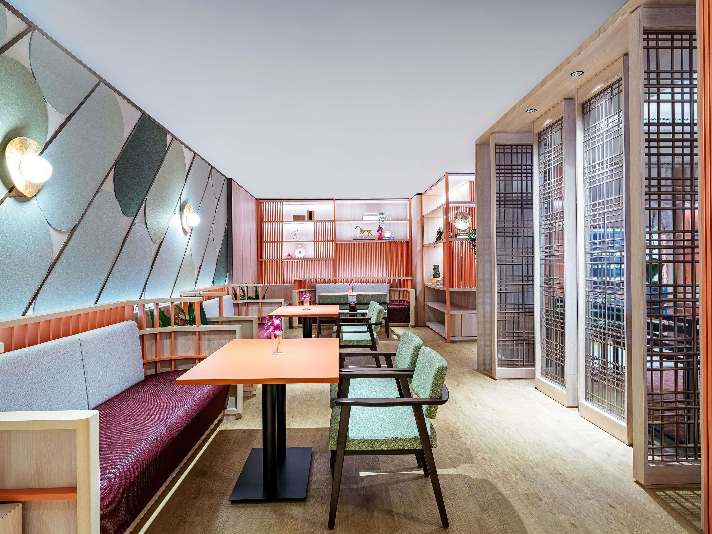 A modern interior with seating, tables, and decorative shelving.