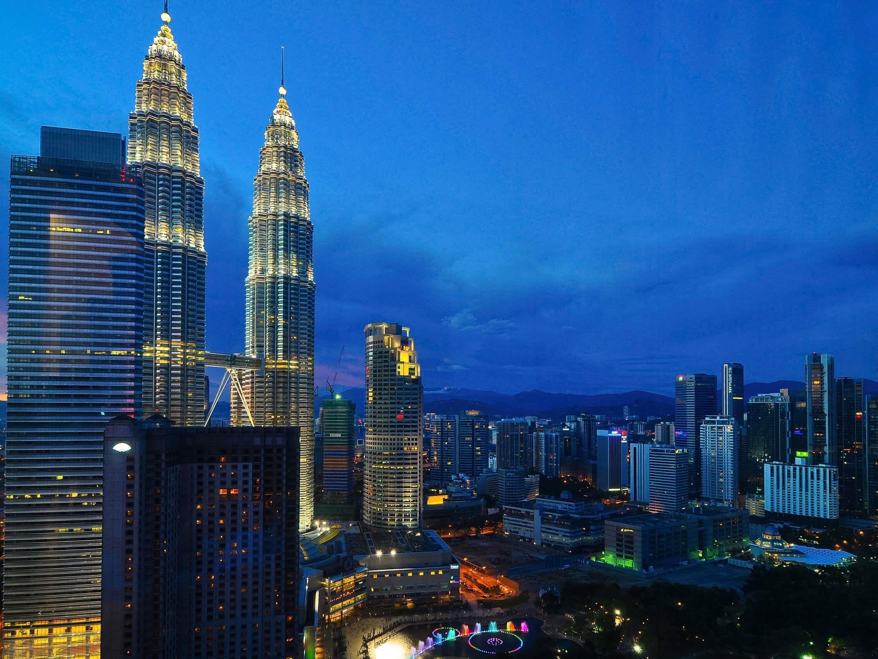 A cityscape with two prominent skyscrapers, one with a distinctive spire.