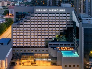 A modern hotel building with a prominent 'GRAND MERCURE' sign, multiple balconies, and a rooftop pool area. - Grand Mercure Kuala Lumpur Bukit Bintang (Kuala Lumpur)