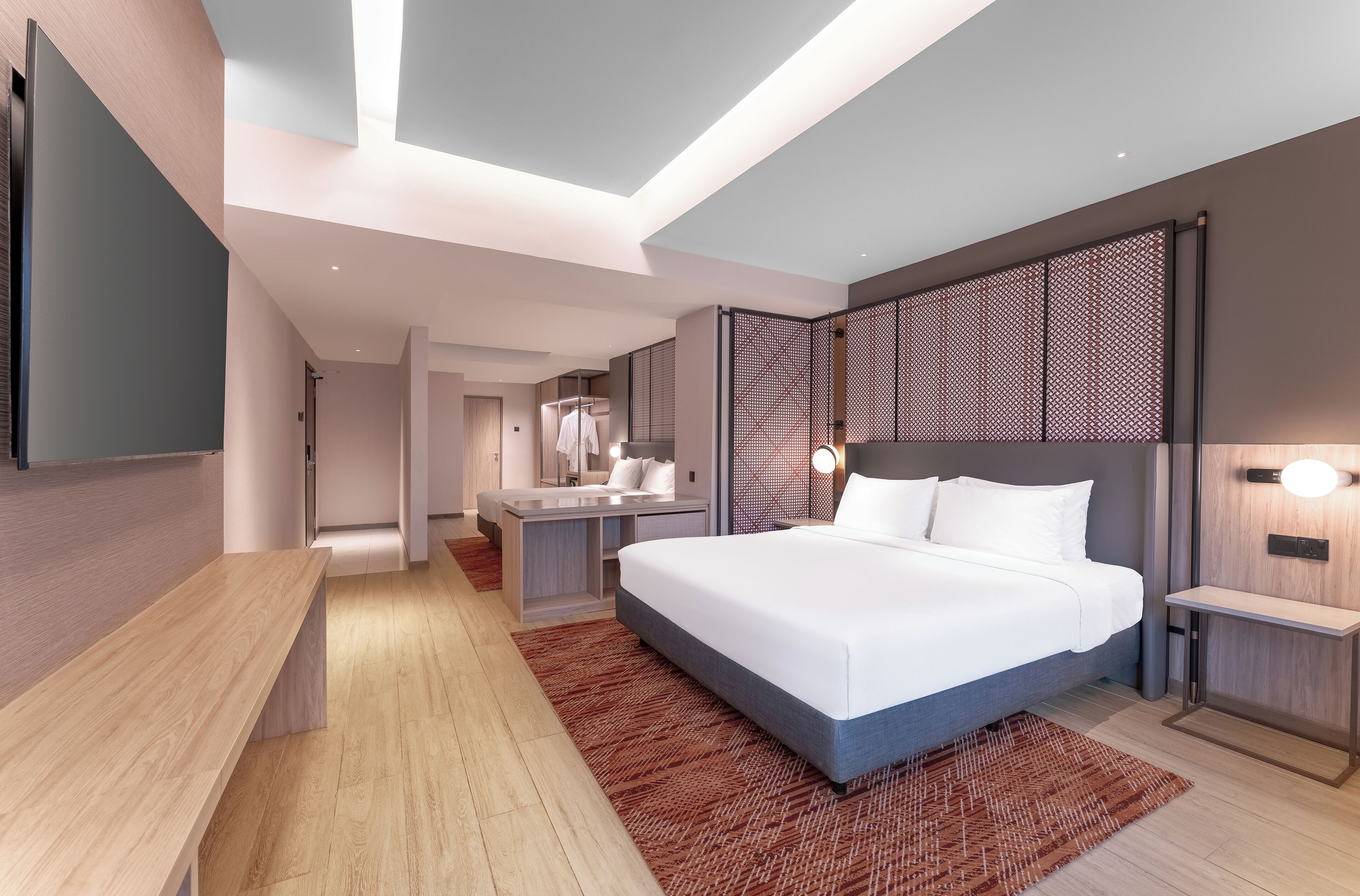 Deluxe Family Room | Minibar, in-room safe, desk, laptop workspace