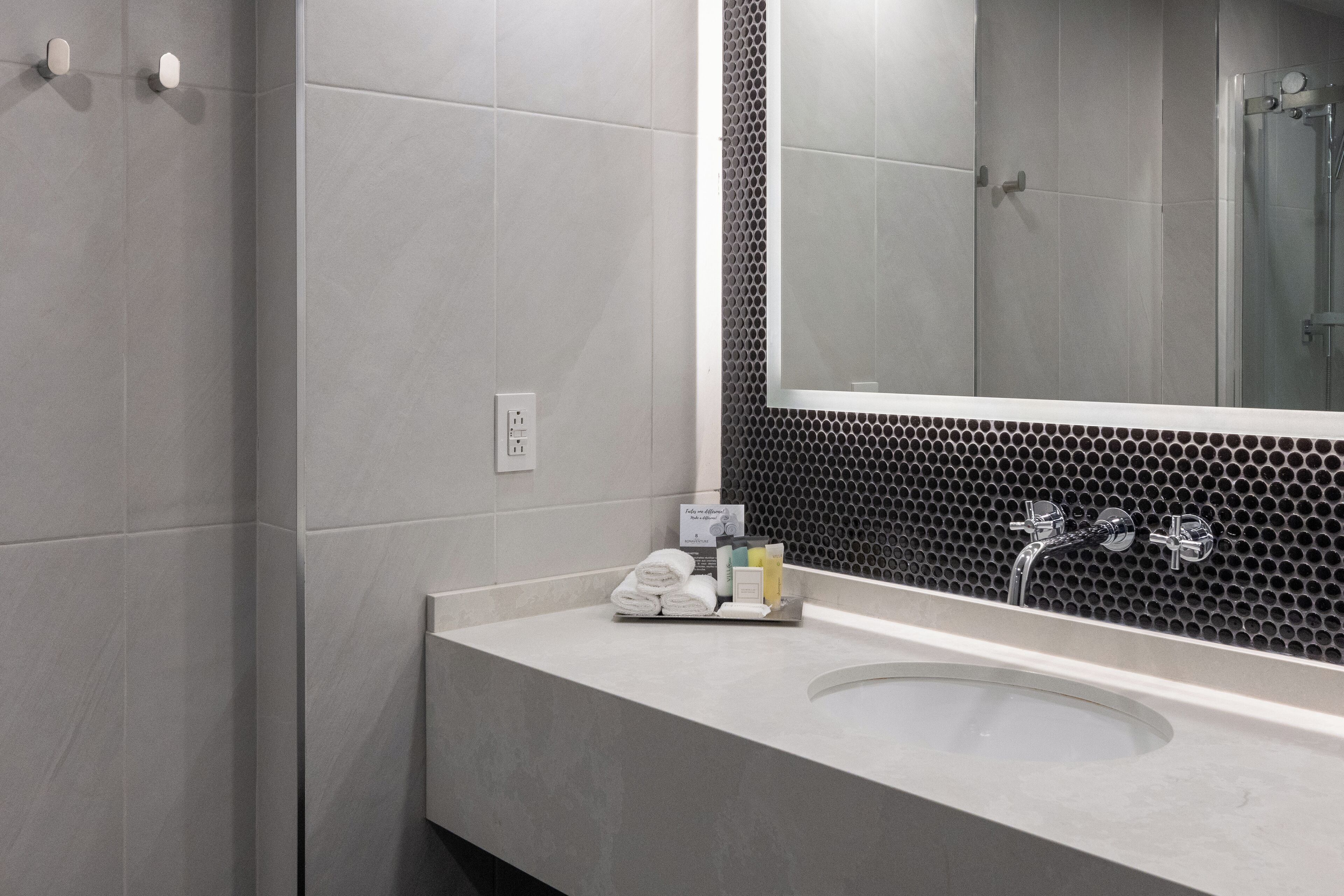 combined shower/bathtub, designer toiletries, hair dryer, bathrobes