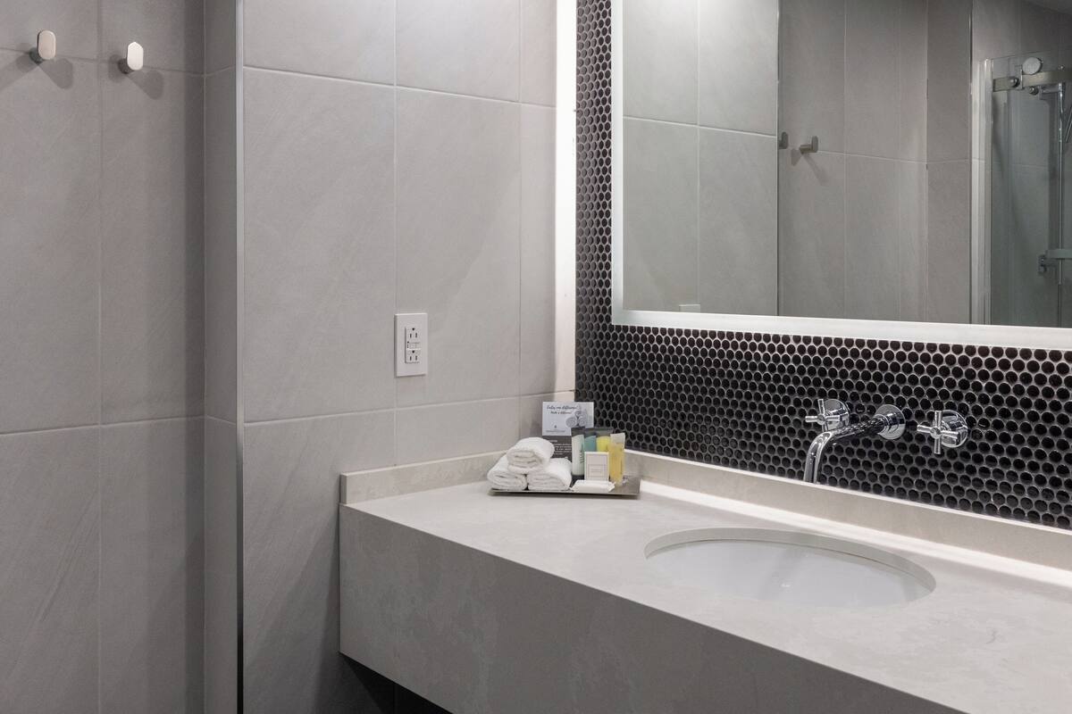 combined shower/bathtub, designer toiletries, hair dryer, bathrobes