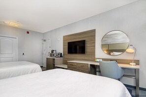A hotel room with two beds, a desk with a chair, a TV, a mirror, and a small kitchenette. - Hilton Garden Inn Livermore (Livermore)