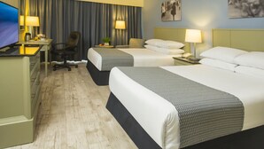 A hotel room with two beds, a desk with a TV, a chair, a desk lamp, and a nightstand with a phone. - Krystal Urban Ciudad Juárez by US Consulate (Ciudad Juárez)