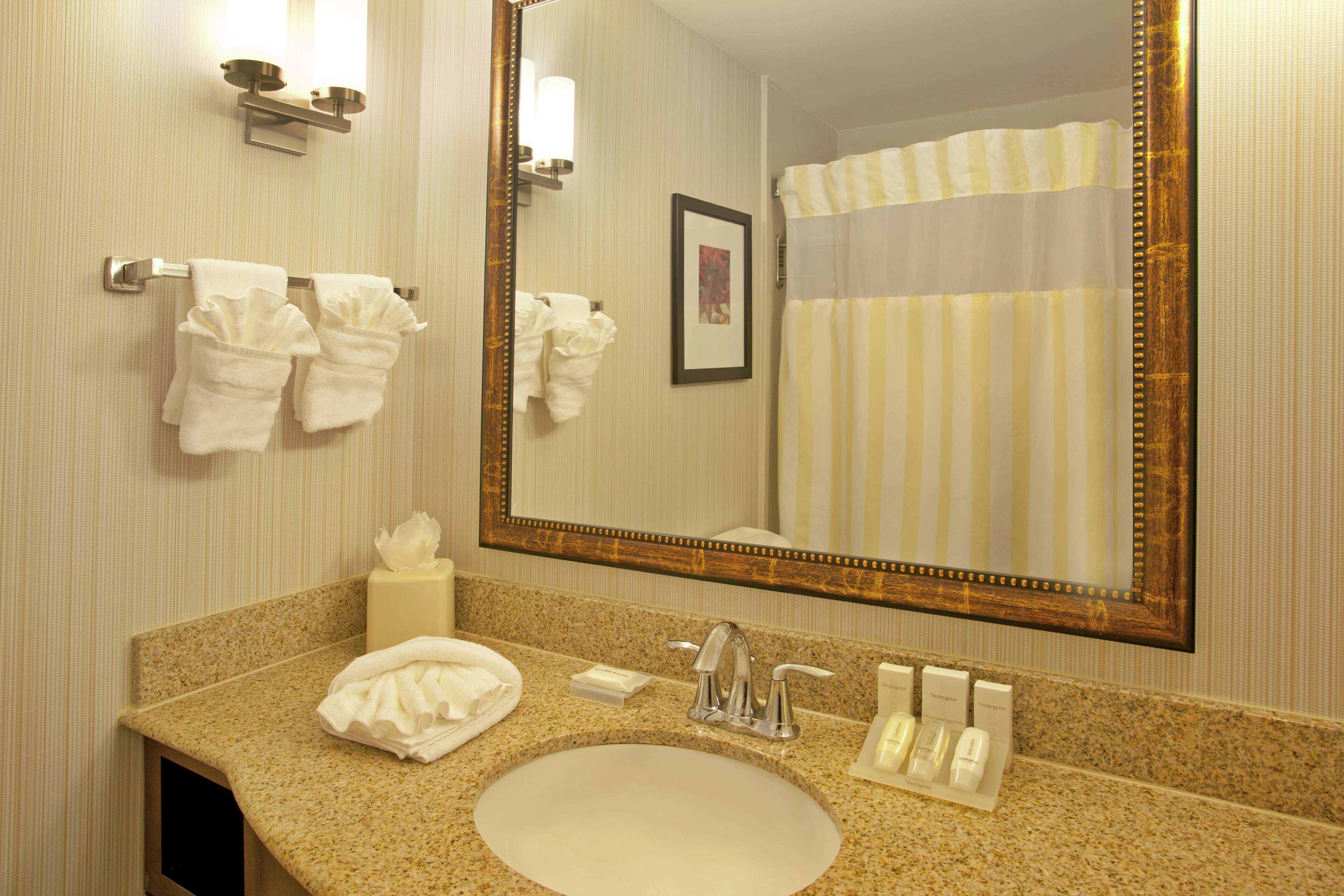 combined shower/bathtub, designer toiletries, hair dryer, towels