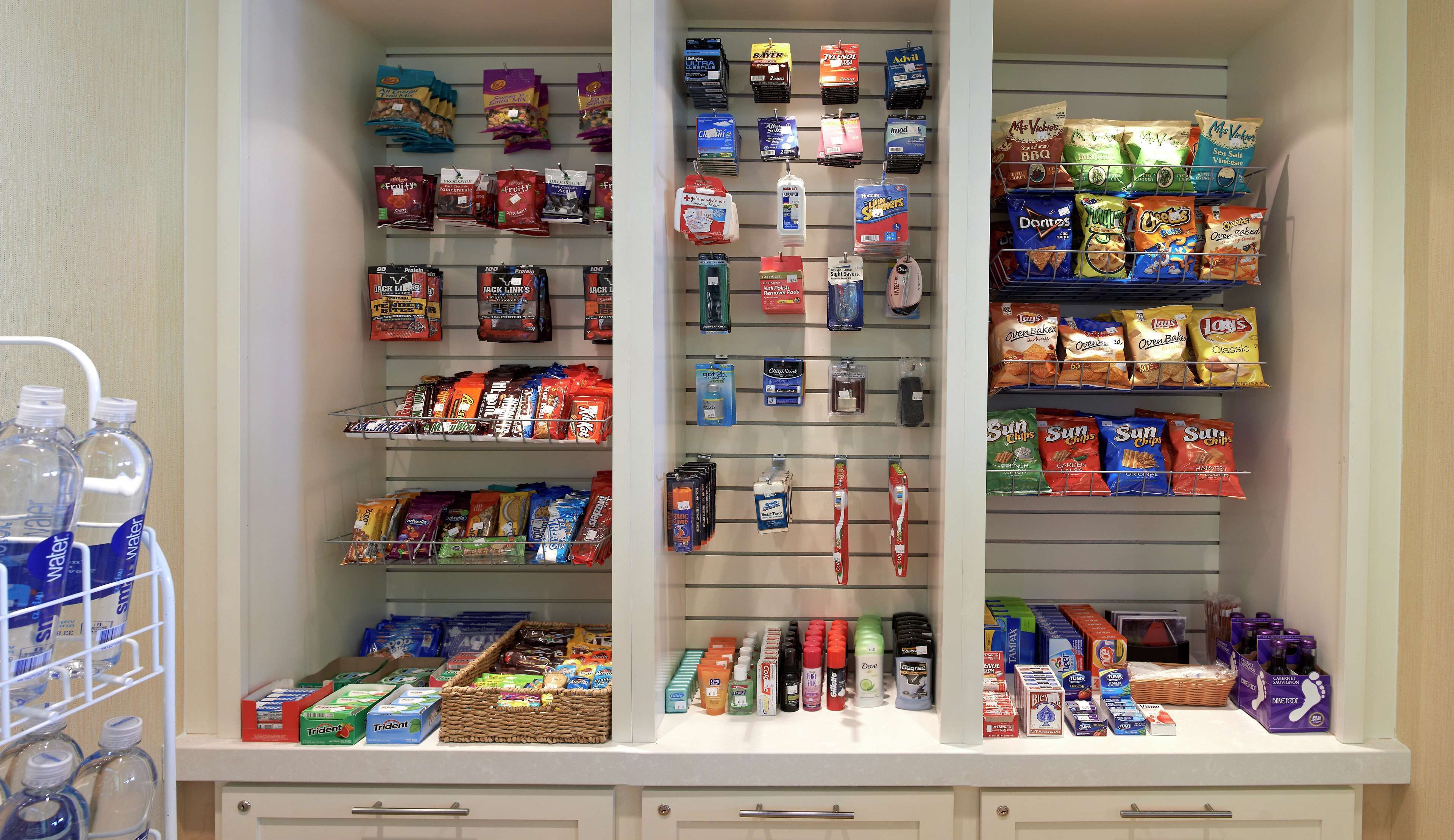 A well-organized pantry with various food items, snacks, and household supplies.