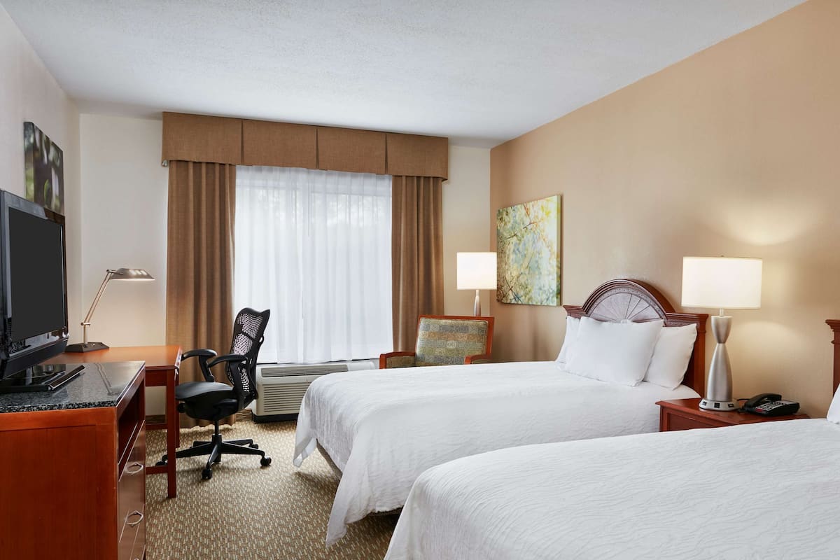 Premium bedding, desk, laptop workspace, blackout drapes