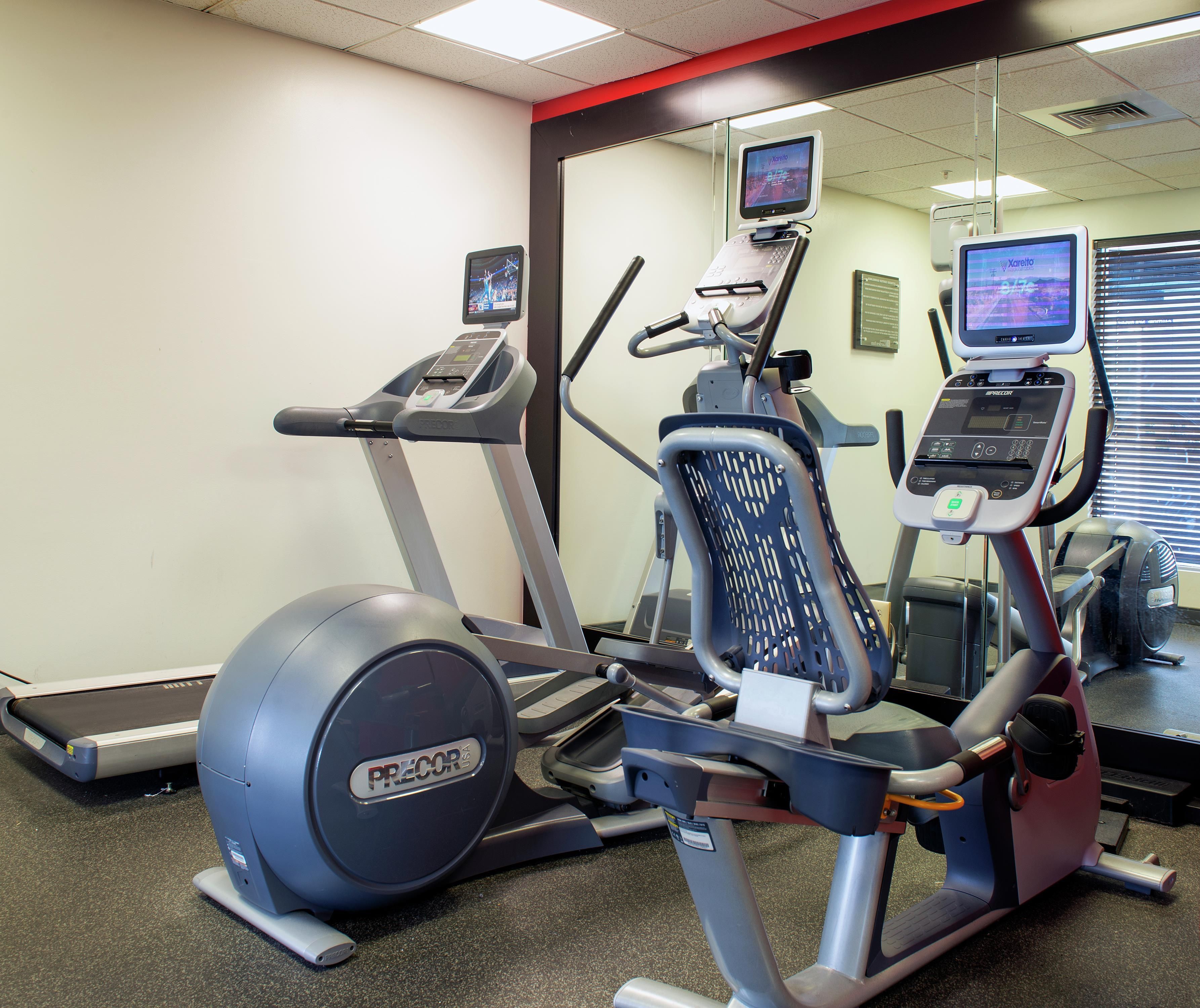 A fitness center with treadmills, an elliptical, and exercise bikes.