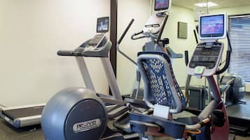 A gym with treadmills, an elliptical, and exercise bikes.