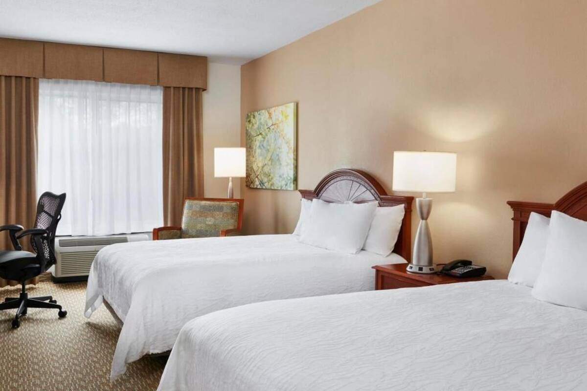 Premium bedding, desk, laptop workspace, blackout curtains