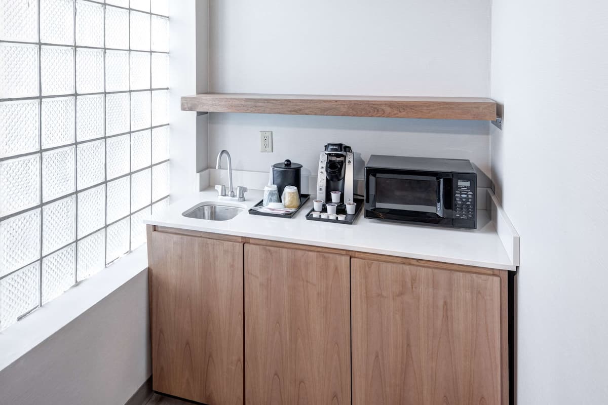 room, 1 king bed with sofa bed (wet bar) | desk, laptop workspace, iron/ironing board, free cots/infant beds