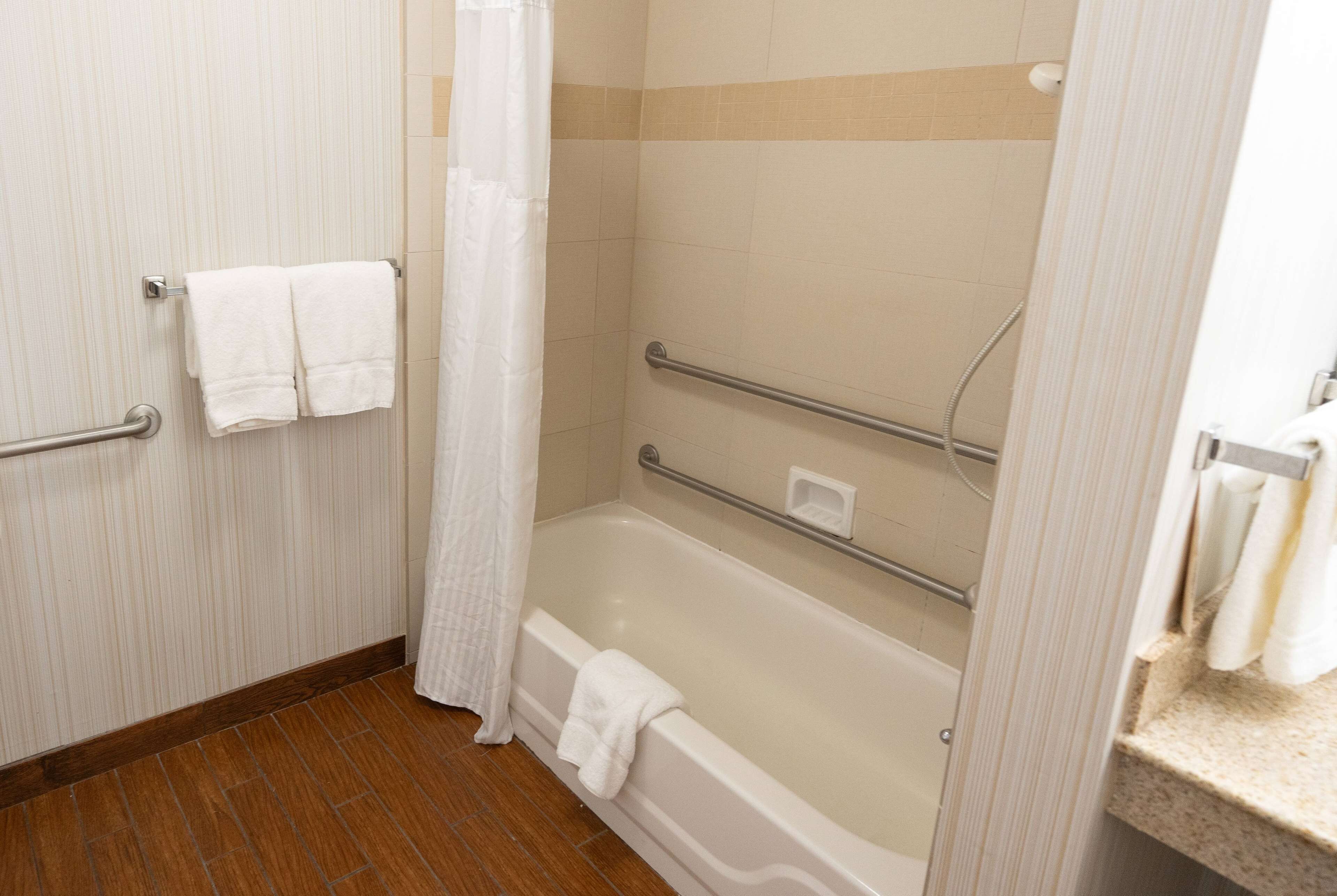 room, 1 king bed, mobility accessible, non smoking (hearing, bathtub w/ grab bars) | bathroom | combined shower/bathtub, designer toiletries, hair dryer, towels