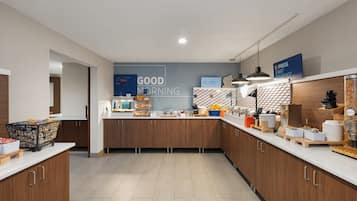 A modern kitchen with wooden cabinets, a breakfast bar, and a sign that reads 'GOOD MORNING'.