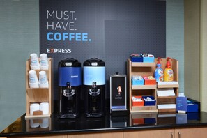 A coffee station with two coffee dispensers, a hot water station, and a coffee grinder. - Holiday Inn Express Durham by IHG (Durham)