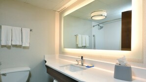 A bathroom with a white sink, a mirror, and a toilet. - Holiday Inn Express Durham by IHG (Durham)