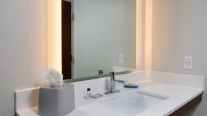 A bathroom with a white sink, a mirror, and a tissue holder. - Holiday Inn Express Durham by IHG (Durham)
