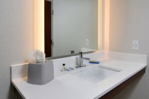 A bathroom with a white sink, a mirror, and a tissue holder. - Holiday Inn Express Durham by IHG (Durham)