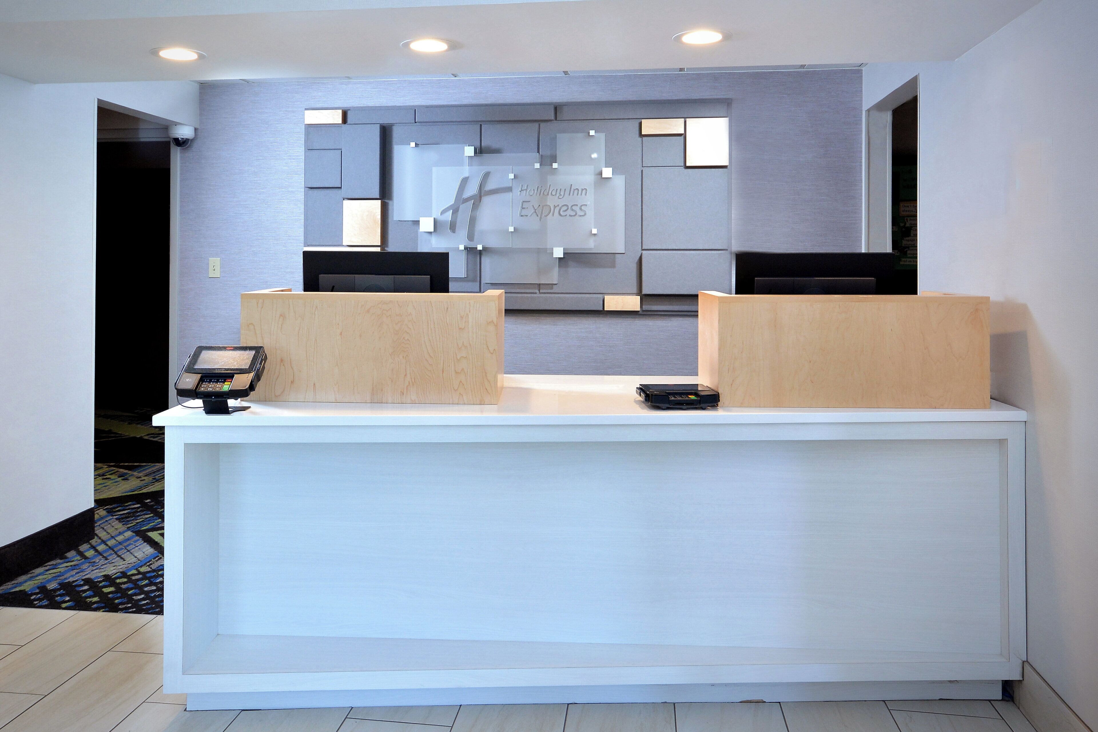 A reception desk with a modern design, featuring a flat surface and two wooden counters.