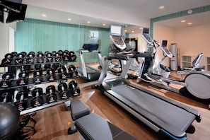 A gym with treadmills, elliptical machines, and a rack of dumbbells. - Holiday Inn Express Durham by IHG (Durham)