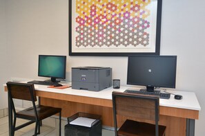 A workspace with two monitors, a printer, and a chair. - Holiday Inn Express Durham by IHG (Durham)
