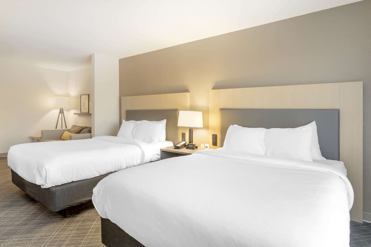 suite, 2 queen beds, non smoking | in-room safe, desk, iron/ironing board, free cots/infant beds