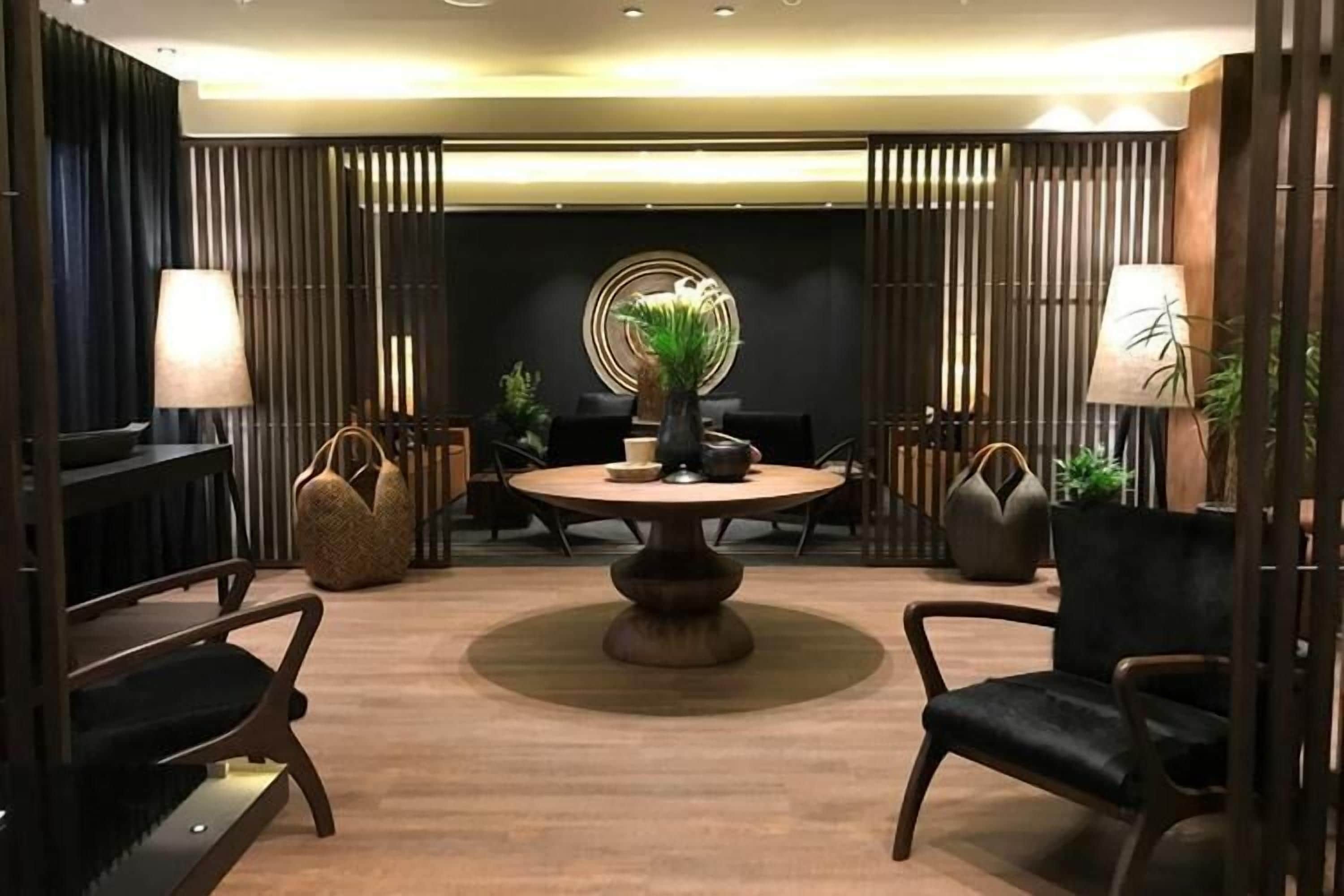A modern dining area with a round table, chairs, and decorative elements.